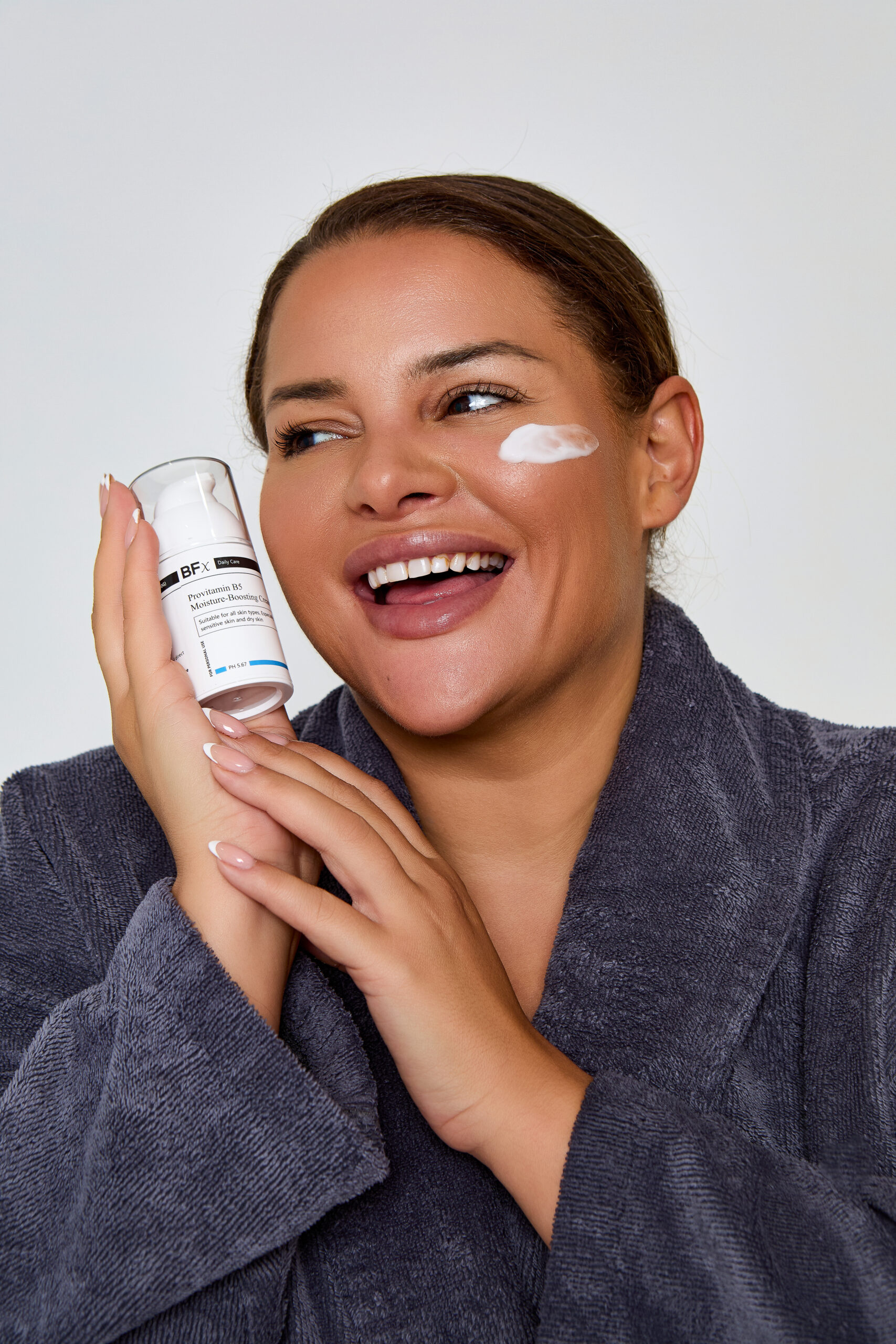 Lady with Pro B5 moisturising cream smudged on her cheek. The lady is smiling