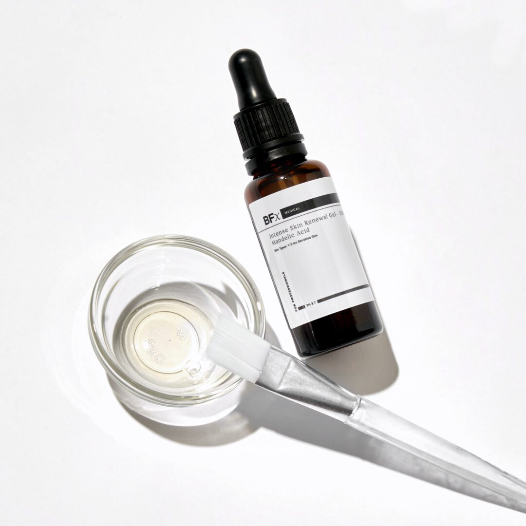 BFx Chemical Peel product bottle and spatula lying on a white table face up