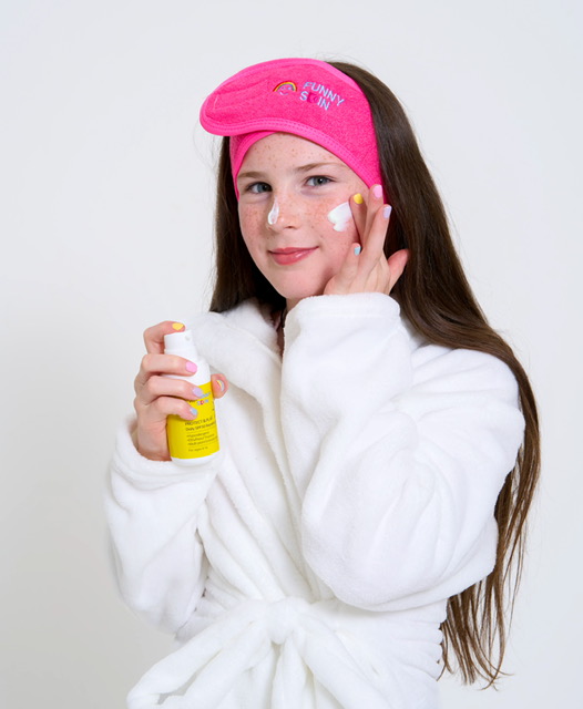 BossFace Kids0251 A tween girl using Protect and play skincare by funny skin with the product on her cheek