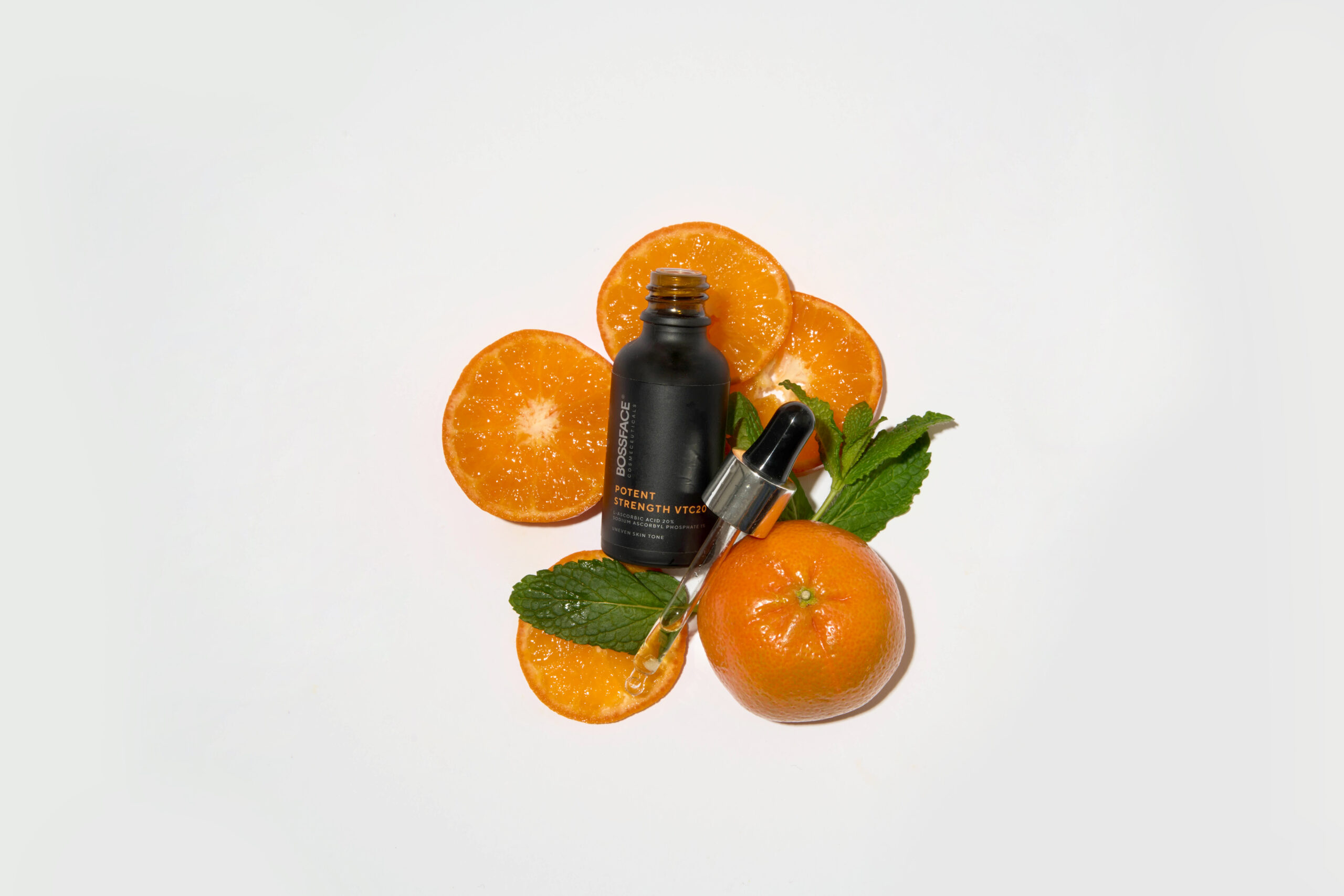 Bossface VTC20 product black bottle lying on oranges